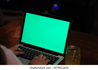 Over The Shoulder Of Hand Typing On Laptop Computer At Dark Night