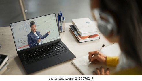 Over the Shoulder Shot with a College Student Studying Engineering in a Library. Anonymous Female Learning Online, Getting Ready for Technical Exams - Powered by Shutterstock