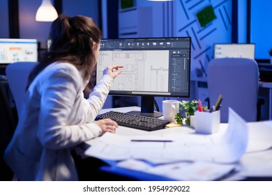 Over the shoulder shot engineer woman drawing architectural plans   looking at cad software desktop computer  Designer using arhitecture blueprints buildings creating industrial prototype