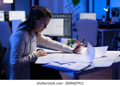 Over the shoulder shot engineer woman drawing architectural plans   looking at cad software desktop computer  Designer using arhitecture blueprints buildings creating industrial prototype
