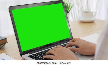 Over The Shoulder Shot Of A Woman Typing On A Computer Laptop With A Key-green Screen. Woman Hand Typing  Laptop With Green Screen.