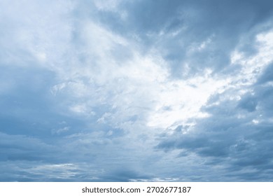 Overcast blue sky filled with dramatic thick gray and white storm clouds suggesting impending weather