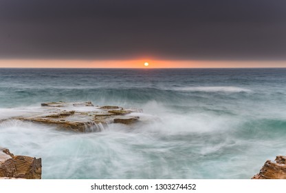 Overcast Coastal Seascape Sunrise from a Sandstone Headland -  North Avoca Beach on the Central Coast, NSW, Australia.