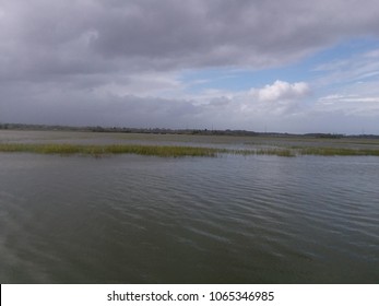 An overcast view of the ocean scenery landscape with very calm still waters.