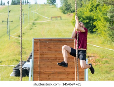 Overcome obstacle using rope during extreme race in the boot camp - Powered by Shutterstock