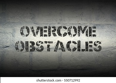 Overcome Obstacles Stencil Print On The Grunge White Brick Wall