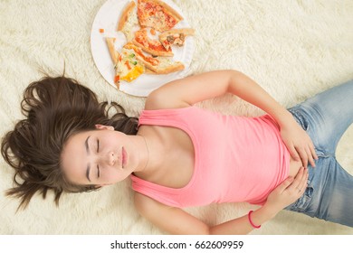  Overeat Unhappy Woman With Pieces Of Pizza On White Background