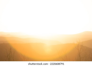 Overexposed Bright White Sunlight Lens Flare Over Mountain Range Forest