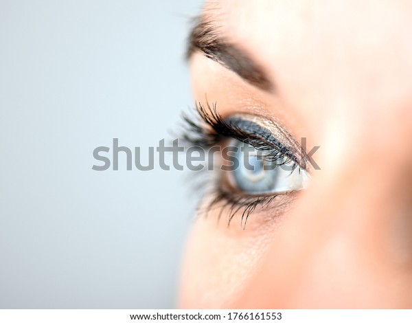 Overexposed close up of a young woman\'s right eye in\
side view