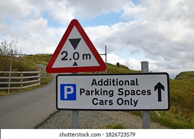 Overflow Car Park Sign At Lealt Falls, Isle Of Skye With Two Metre Height Restriction, Parking Icon, Text Additional Parking Spaces Cars Only With Blurred Height Barrier, Road And Grass.