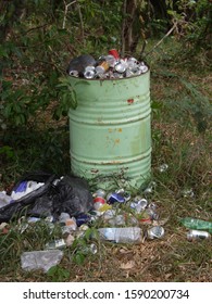 Overflowing Garbage Can In Woods