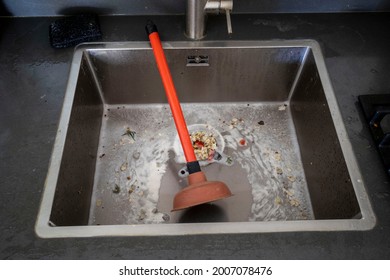 Overflowing Kitchen Sink, Clogged Drain. Plunger (force Cup) In The Sink. Plumbing Problems.