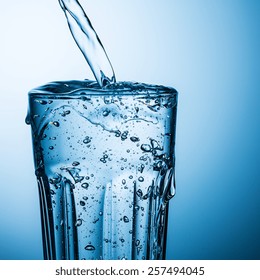 Overflowing Water In A Glass