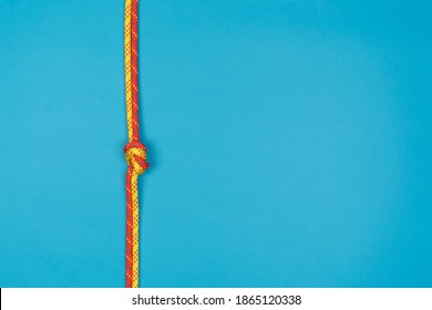 Overhand Knot With Red And Yellow Climbing Rope On Blue Backgrou