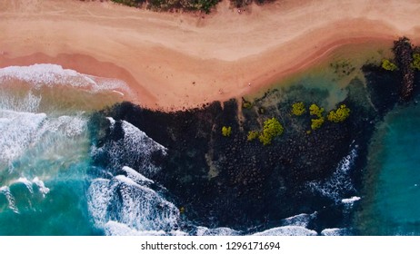 Overhead Aerial Shot Of Waves Crashing On The Beach, Rocks And Rock Pools