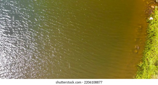 Overhead Aerial View Of Lake Water In Summer.