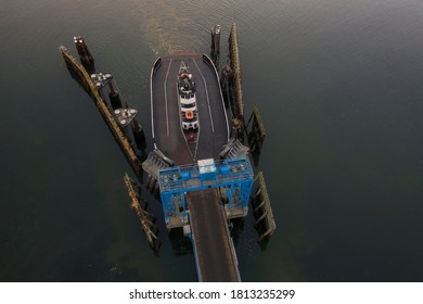 Overhead Aerial View Of A Small Ferryboat Docking On Lummi Island. The 21 Car Ferry Services This Small Island Near The City Of Bellingham In The Salish Sea Area Of The Pacific Northwest.