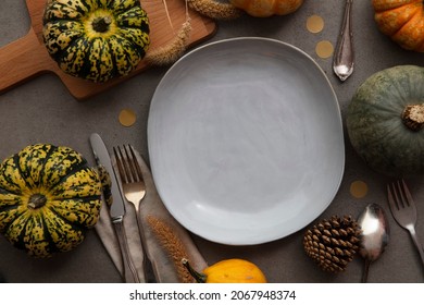 Overhead Autumn Thanksgiving Dinner Place Setting With Pumpkins Cutlery And An Empty Plate