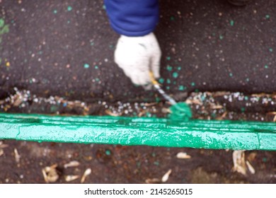 Overhead Blurred Motion Shot Of A Hand With Brush Painting Metal Fence