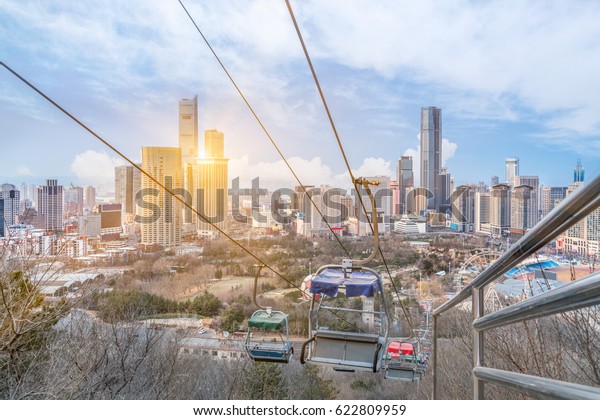 Overhead Cable Car with cityscape in\
background,shot in\
Shanghai,China.