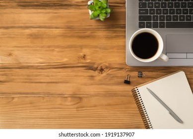 Overhead close up above flat lay view photo of laptop keyboard with mug of beverage green succulent and clear spiral copybook isolated brown loft backdrop with blank space - Powered by Shutterstock