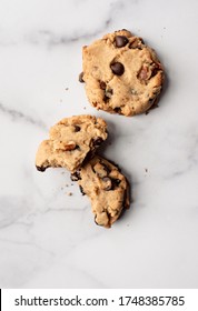 Overhead Close Up Of Chocolate Chip Cookies On White Marble Counter.