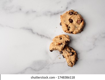 Overhead Close Up Of Chocolate Chip Cookies On White Marble Counter.