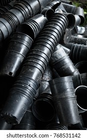 Overhead Close Up On A Long Stack Of Empty Plastic Planter Pots, Nesting In A Row, Atop A Pile Of Discarded Containers 