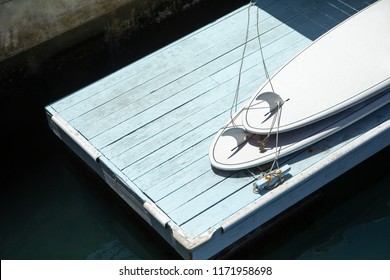 Overhead Close Up On A Pair Of Stand Up Paddle Boards On A Lake Dock, With Space For Text On The Left