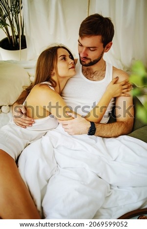 Similar – Beautiful woman looking to man lying on bed