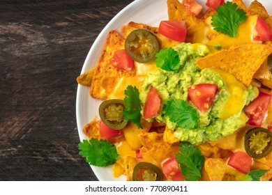 An Overhead Closep Photo Of Nachos With Queso, Traditional Mexican Snack, On A Rustic Background With A Place For Text