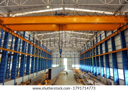 Overhead crane and concrete floor inside factory building for industrial background