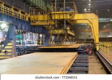 Overhead crane with magnetic lift in the shop for manufacturing large diameter pipes - Powered by Shutterstock