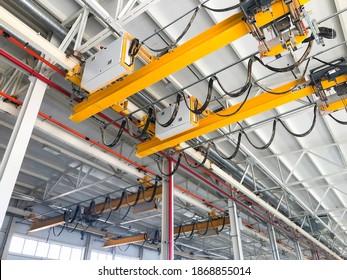 Overhead cranes inside industrial building. Bridge cranes inside hangar - Powered by Shutterstock