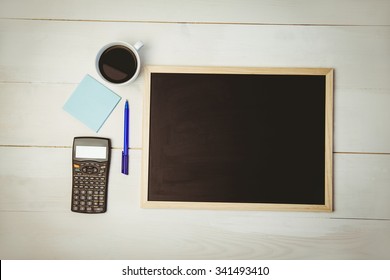 Overhead Of Desk With Chalkboard And Calculator Shot In Studio