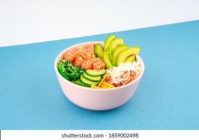 An overhead diagonal, isometric projection photo of poke bowl, traditional Hawaiian and Japanise raw fish salad, from seaweed, rice, salmon, cucumber, soy sause and avocado. with chopsticks and sesame - Shutterstock ID 1859002498