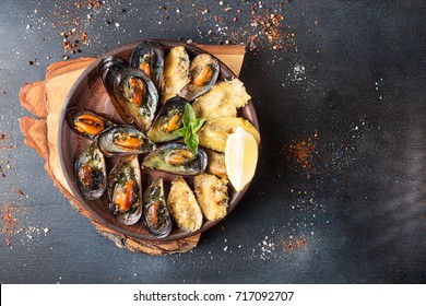 Overhead Of Dinner Table. Assorted Delicious Grilled Barbecue Meat And Seafood. Pork Teaks, Trout, Mussels, Shrimps, Dried Tomato, Cherry Tomato, Chili Pepper, Glasses Of Wine.Bbq Party Concept.