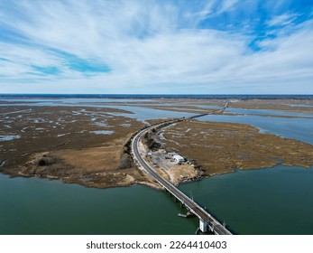 Overhead drone aerial view curved road and several bridges over several small islands in secluded bay