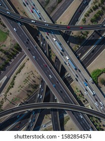 An Overhead Drone Shot Of A Busy Highway Intersection Full Of Traffic During Daytime