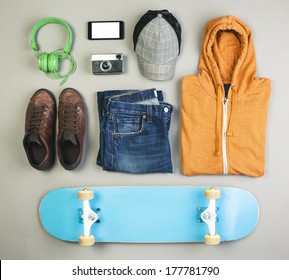 Overhead of essentials casual boy./ Outfit of skater man on grey background. 