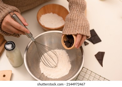 Overhead, Female Adding Chocolate Chips Into A Mixing Bowl, Preparing Cookie Dough In The Kitchen.