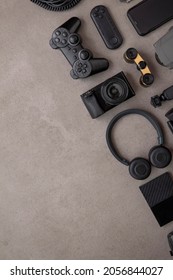 Overhead Flat Lay Of Black Technology Devices And Gadgets On A Grey Background