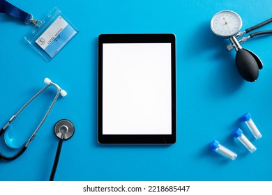 Overhead Flat Lay Medical Shot Of Stethoscope Digital Tablet ID Lanyard Tubes And Sphygmomanometer