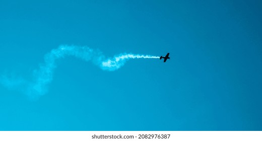 Overhead flying aircraft. Aircraft in formation during an aerobatics display as they loop and roll through the sky. Plane engine failure. Falling airplane crashes