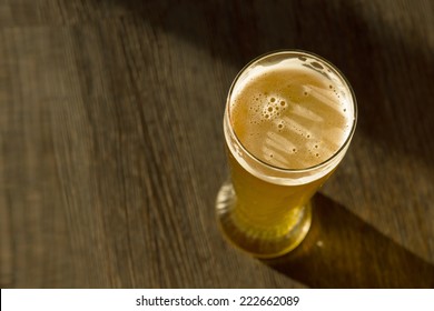 Overhead Of Glass Of Beer On Table In Sunlight