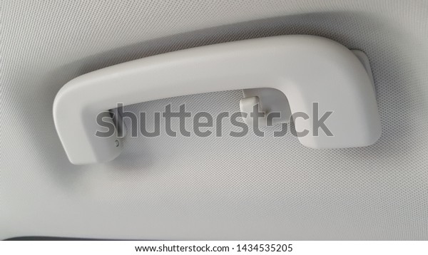 Overhead\
grab handle in car, showing handle and coat\
hook