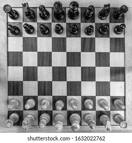 An Overhead Grayscale Shot Of Chess Pieces On The Board