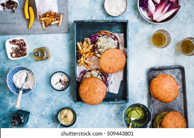 Overhead Of Hamburgers And Appetizers Party Menu. Dinner Food Table. Top View.