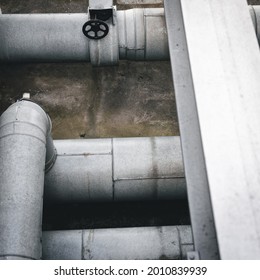 An Overhead Of Huge White Pipes Of Water With Black Valve