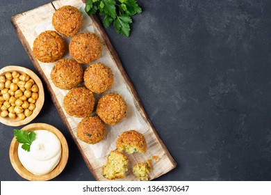 Overhead image of arabic snack falafel in the form of chickpea balls with spices. Dark slate background.